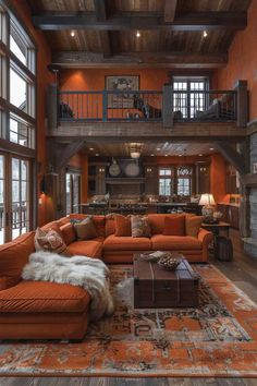 a living room filled with lots of furniture and large windows in front of the fireplace