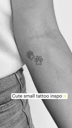 small dog paw tattoo on the arm