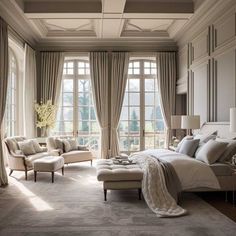 an elegant bedroom with large windows and beige furniture