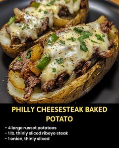 two stuffed potatoes on a black plate with cheese and green peppers in the middle, labeled philly cheesesteak baked potato