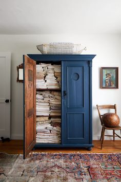 a blue armoire with lots of papers in it