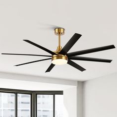 a ceiling fan with black blades hanging from it's center in an empty room