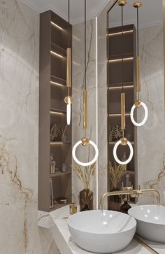 two sinks in a bathroom with gold fixtures and white marble counter tops on both sides