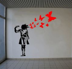 a woman is blowing the butterflies out of her hair in an empty room with white tile flooring