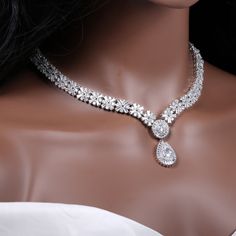 "Gorgeous crystal bridal jewelry set for your wedding day: necklace, bracelet and earrings.  This wedding jewelry set is available in silver color.  Necklace measures about 17 1/2\" long.  Earrings are about 1 3/4\" long and 3/4\" wide. Matching regular bracelet is measuring: 7\" long and 1/2\" wide or an adjustable bolo matching bracelet is available as well, Just contact me. High quality guaranteed by Latasha Bridal!" Silver Bridal Necklace With Elegant Cubic Zirconia Design, Silver Bridal Necklace With Cubic Zirconia, Silver Crystal Jewelry Sets With Elegant Design, Silver Crystal Bridal Sets For Anniversary, Silver Crystal Jewelry Sets For Brides, Bride's Silver Crystal Jewelry Sets, Silver Teardrop Jewelry Sets With Elegant Design, White Cubic Zirconia Bridal Jewelry, Silver Crystal Bridal Sets