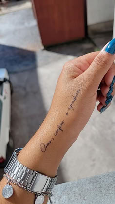 a woman's hand with a small tattoo on her left wrist that says, i love you