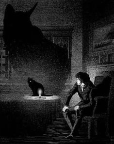 a man sitting in a chair next to a black cat on the floor at night