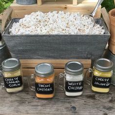 a wooden table topped with jars filled with food