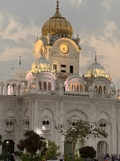 a large white building with a clock on it's side