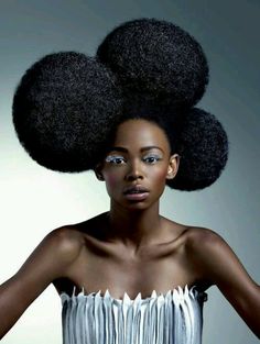 a woman with large afros on her head