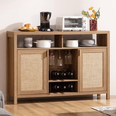 a wooden cabinet with wine glasses and other items on it in a living room area