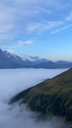 the mountains are covered with low lying clouds in the foreground, and there is no image to provide a caption for