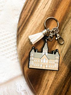 a wooden keychain with a building on it