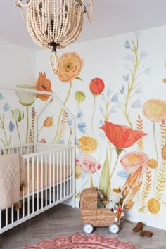 a baby's room with floral wallpaper and a crib