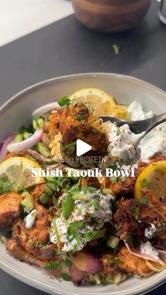 a bowl filled with lots of food on top of a table