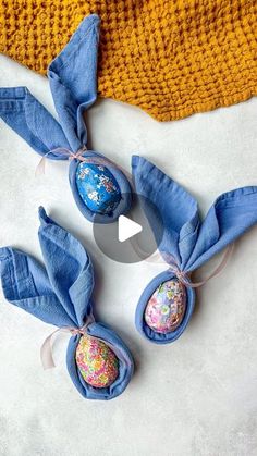 three easter eggs wrapped in blue linen