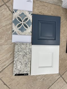 the floor is covered in different types of tile and cabinet doors, including one with an open door