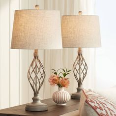 two lamps sitting on top of a wooden table