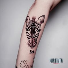 a zebra tattoo on the arm of a person