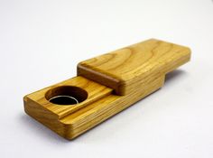 a wooden object with a hole in the middle on a white surface and no one around it