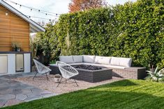 a backyard with a fire pit surrounded by grass