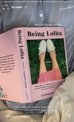 a person is holding a book in their lap with the title being lolia written on it