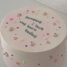 a pink cake with hearts and confetti on it that says someone i love you today