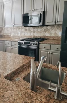 a kitchen with granite counter tops and stainless steel appliances