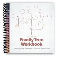 the family tree workbook is open on top of a spiral - bound book,