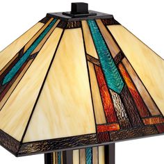 a stained glass table lamp on a wooden base with a blue, green and brown design