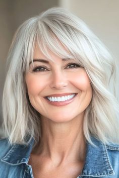 Save this pin for the best medium-length hairstyles for women over 50 with bangs. This layered lob combines the sleekness of a lob (long bob) with the added volume of choppy layers. The result is a voluminous, textured look. Medium Length Hair With Bangs Fine Hair, Gray Bob With Bangs Over 50, Lob Haircut With Bangs Over 50, Long Bob With Bangs Hairstyles, Medium Blonde Hair With Bangs, Medium Layered Bob With Bangs, Mid Length Bob With Bangs, Medium Length Layered Hair With Bangs, Layered Bob Hairstyles With Bangs