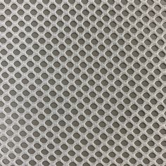 an image of a metal surface with circles and dots in grey tones, as well as the