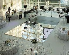 an indoor wedding venue with tables and chairs