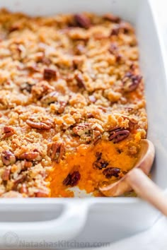 a white casserole dish filled with sweet potato casserole