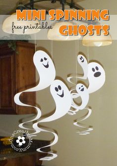 some paper ghost hanging from the ceiling with text overlay that says mini spinning ghosts free printables