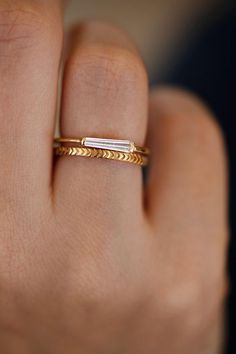 a woman's hand with a gold ring on it