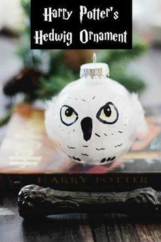 harry potter's hedwig ornament is on top of a book