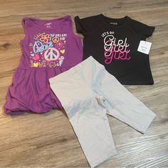 Purple Tank Top Dress Like Shirt Is Brand Extremely Me!, Size 5/6, Is Cinched At Sleeves With Fabric Band And At Bottom Hem With Elastic. Top Is In Euc. Black Shirt Is Jumping Beans Active, Size 5t, And Nwt. Silver Sparkle Shorts Are Bermuda (Knee) Length, Cartwheel Style, And Are 365 Kids Brand And A Size 5. Playful Stretch Black Tops, Playful Black Stretch Top, Black Playful Stretch Top, Cute Short Sleeve Purple Set, Stretch Playful Tops For Playtime, Playful Stretch Tops For Playtime, Casual Stretch Sets For Playwear, Pink Stretch Top For Playtime, Stretch Black Tops For Playwear