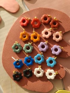 several pairs of colorful earrings on a table