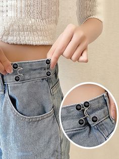 a woman is showing off her jeans with buttons