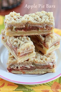 a stack of dessert bars sitting on top of a white plate