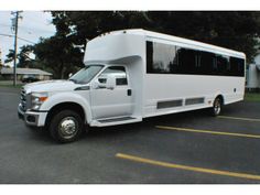 a large white bus parked in a parking lot