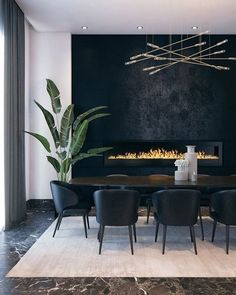 a dining room table with black chairs and a fireplace