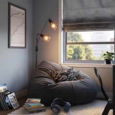 a bean bag chair sitting on top of a rug next to a desk and window