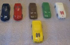 six toy cars are lined up in a row on the floor next to each other