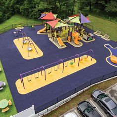 an overhead view of a children's play area with cars parked in the parking lot