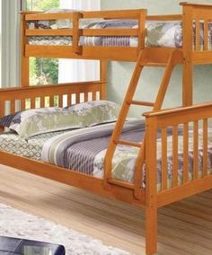 a wooden bunk bed sitting on top of a hard wood floor next to a window