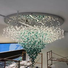 a large chandelier hanging from the ceiling in a room with lots of glass beads