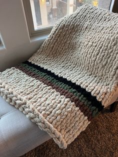 a blanket is laying on the floor next to a window