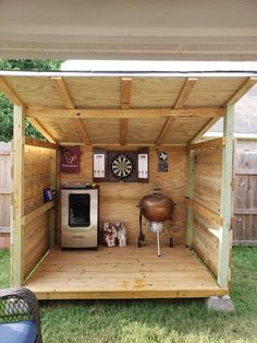 a small wooden shed with an outside bbq